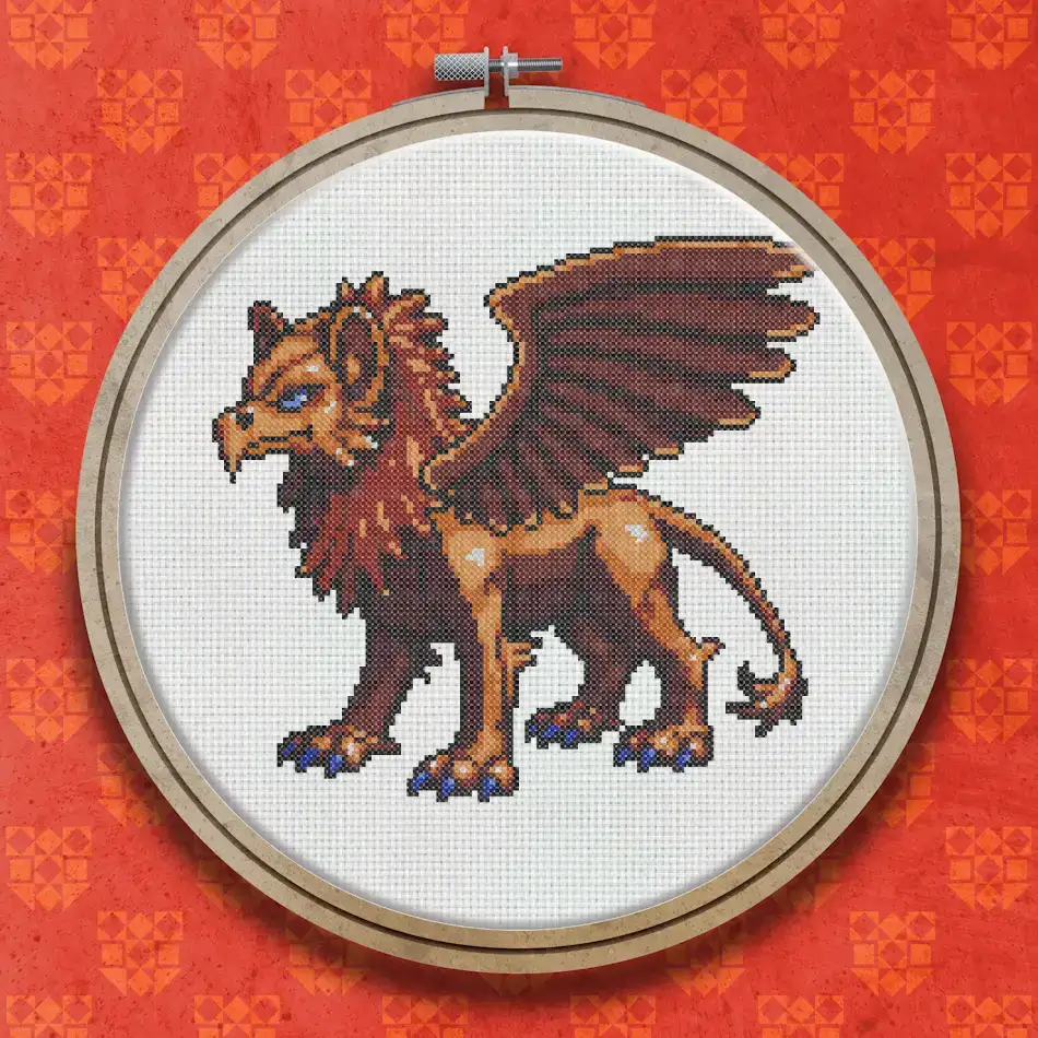 Cross stitch griffin with a tawny lion body, large brown feathered wings, and a detailed feline face, shown in profile facing left.