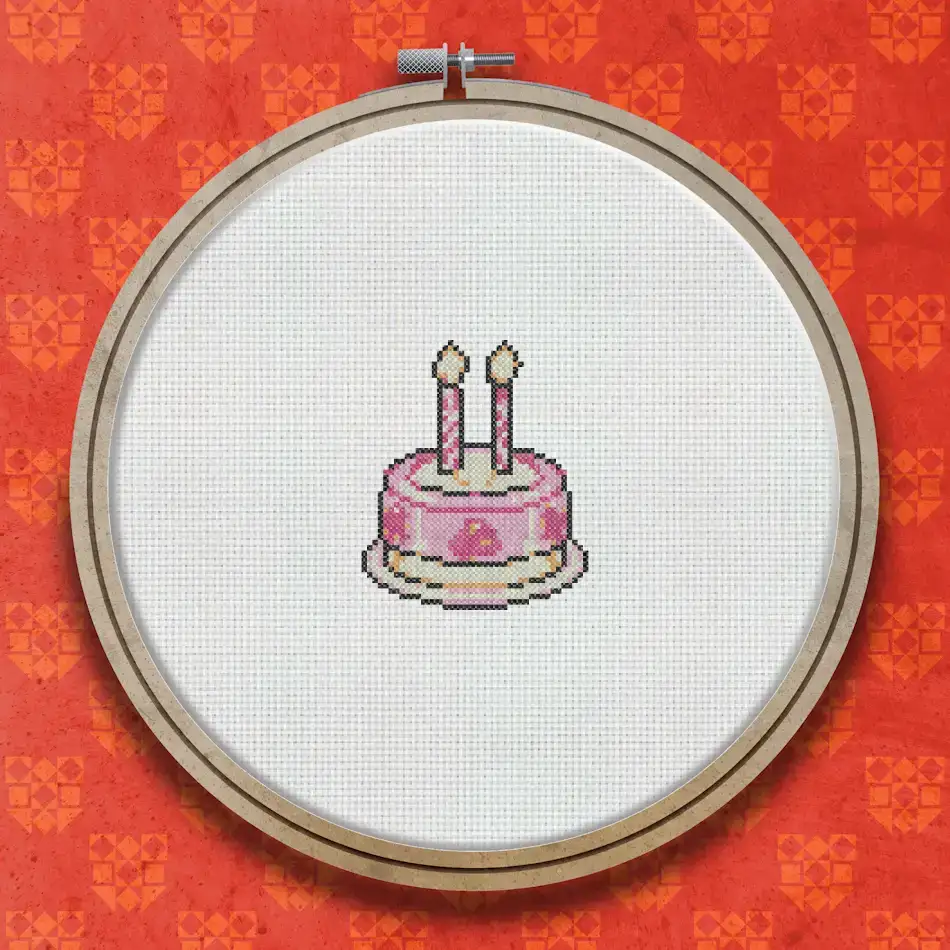 Cross stitch pattern of a pink layered birthday cake with white icing, two lit yellow candles, and a decorative border on a white background.