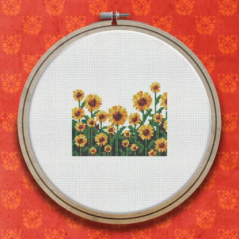 Cross stitch pattern of a row of bright yellow sunflowers with dark centres and green stems against a white background.