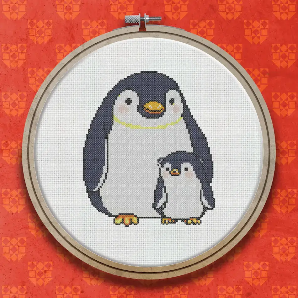 Cross stitch design of a tall adult penguin standing next to a small fluffy penguin chick, both facing forward on a white background.