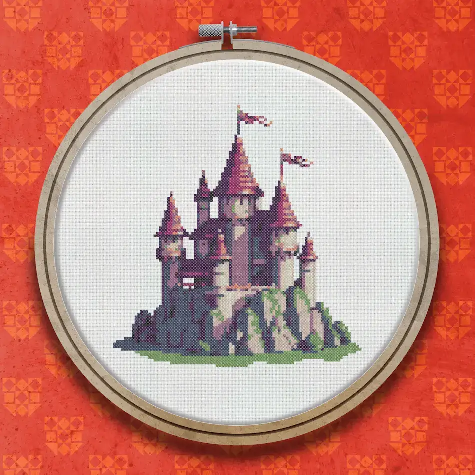 Cross stitch design of a pink and lilac fairytale castle with multiple towers and red pennant flags, set on a rocky grey hilltop.