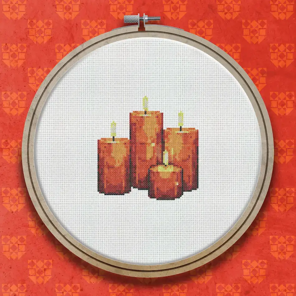 Cross stitch design showing four pillar candles of varying heights in deep red and brown tones with bright golden flames on a dark background.