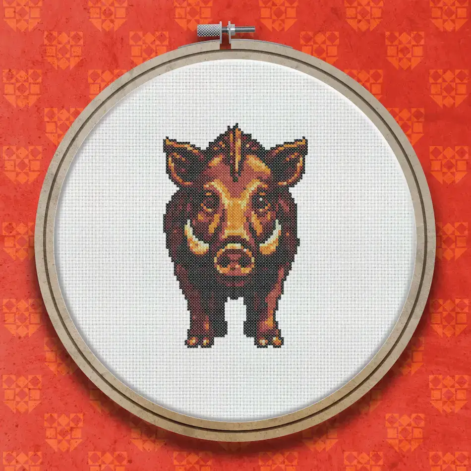Cross stitch design of a wild boar facing forward, rendered in deep amber, russet, and dark brown tones with a dark background.