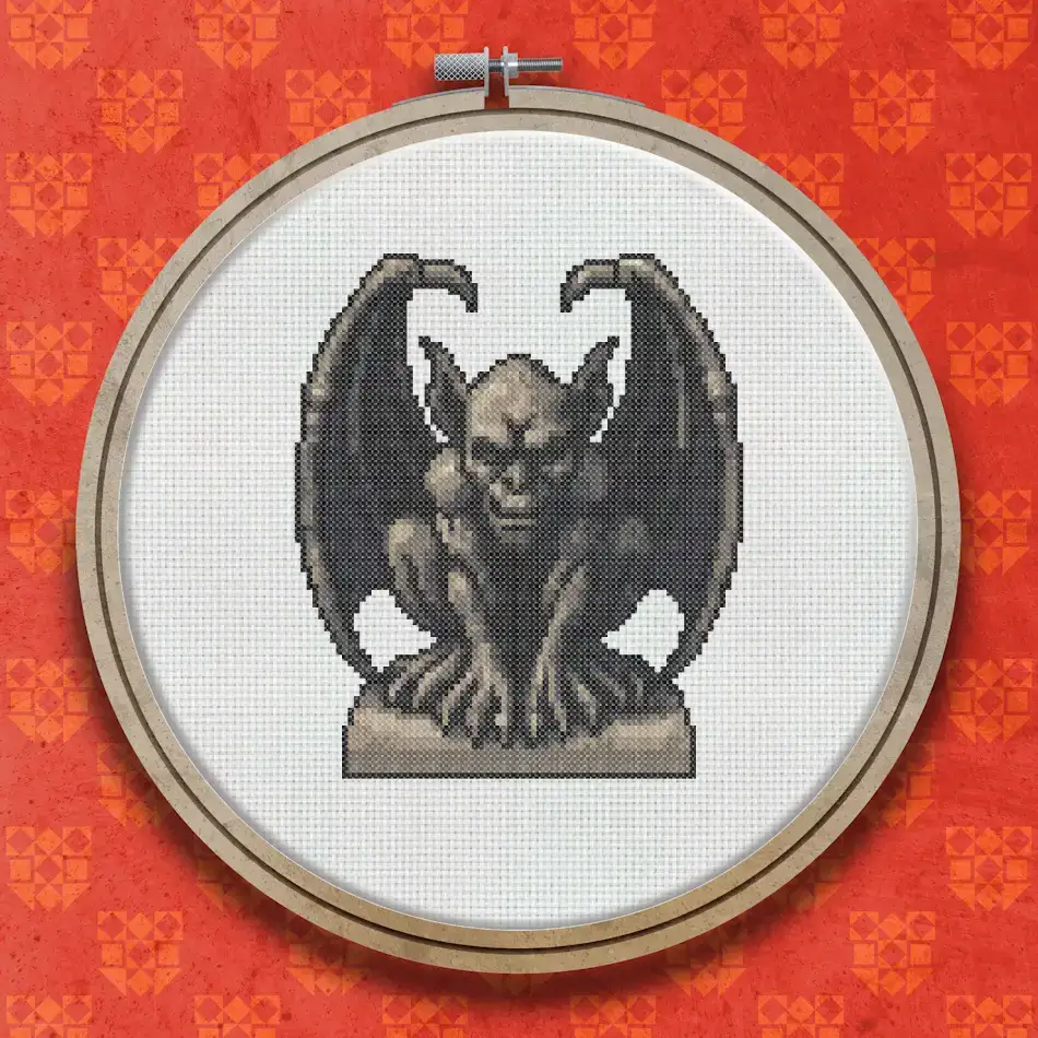 Cross stitch gargoyle seated on a stone plinth, wings raised, rendered in shades of grey with dark shadowing and a menacing expression.