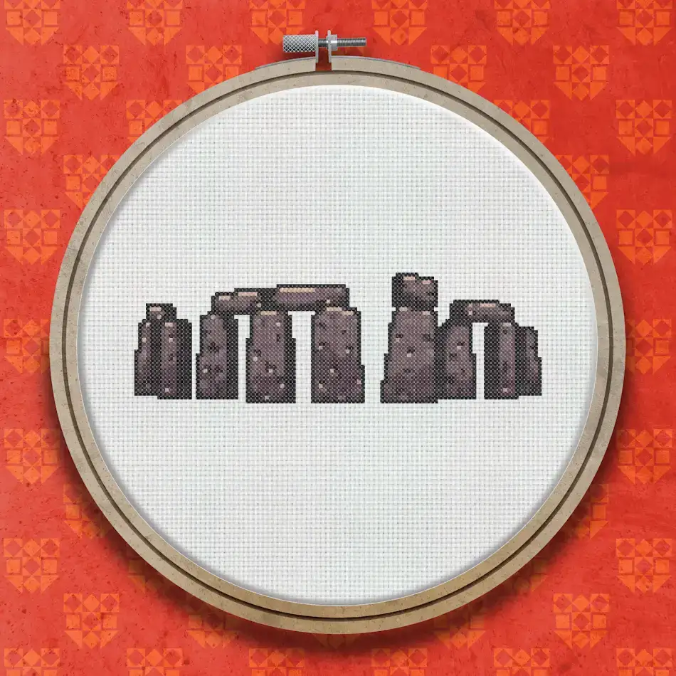 Cross stitch design of Stonehenge showing grey standing stones and lintels in silhouette against a plain background.