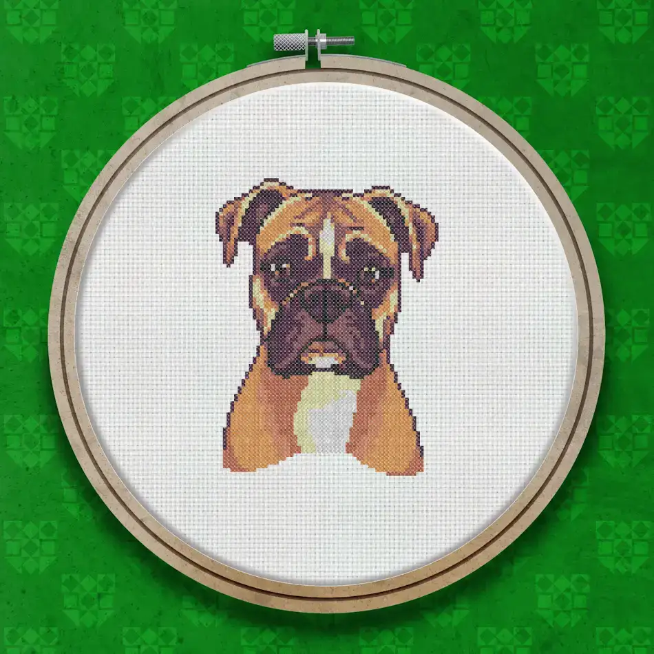 Cross stitch portrait of a fawn and white Boxer dog with a dark muzzle, soft brown eyes, and a gentle, attentive expression on a white background.