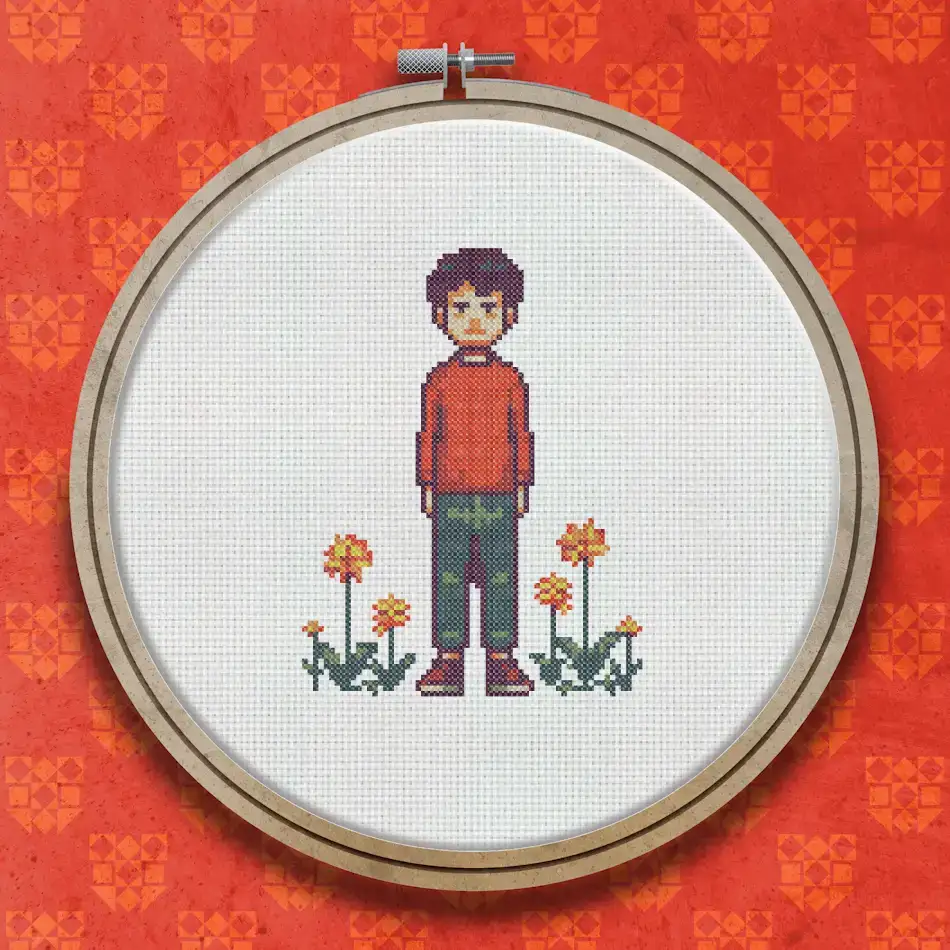 Cross stitch pattern of a dark-haired figure in a red top and grey trousers standing between small red flowers on green stems.