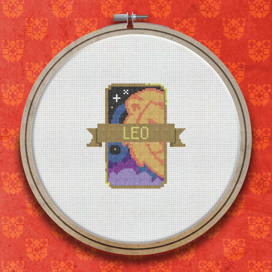 Cross stitch design showing the word LEO on a brown banner ribbon with a warm orange and amber lion motif above it on a dark background.