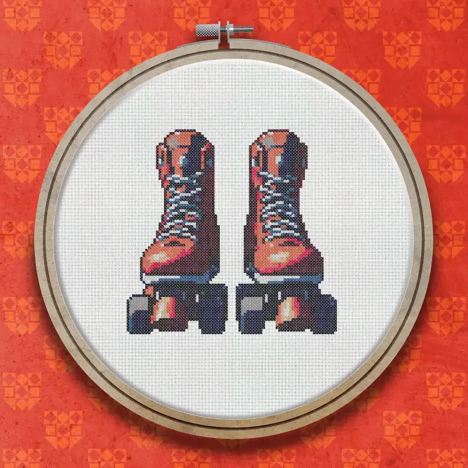 Cross stitch design of a pair of red rollerskate boots with blue wheels and white laces, shown from the front on a white background.
