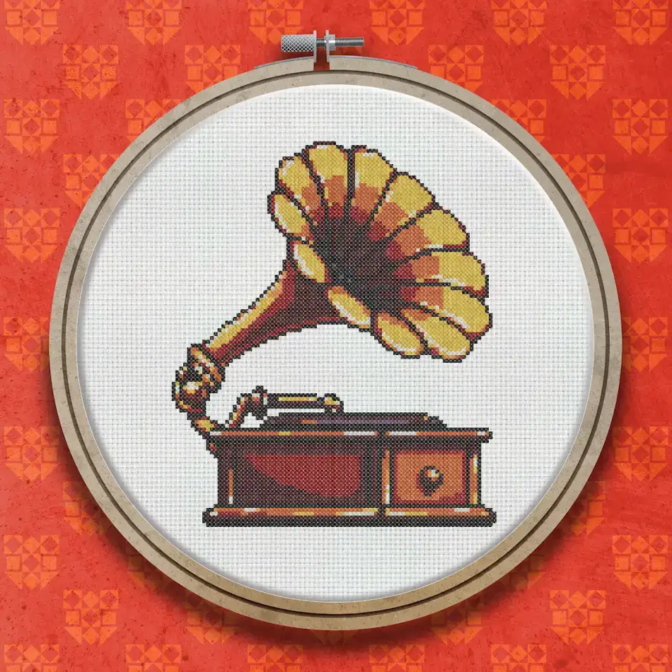 Cross stitch design of a vintage gramophone with a large golden horn and dark wooden cabinet base, shown in warm earthy tones.