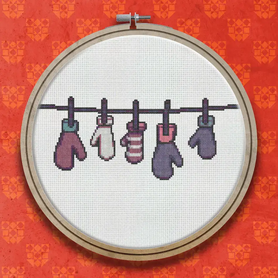 A row of five mittens in pink, white and purple tones hanging on a washing line, each pair slightly varied in colour and style.
