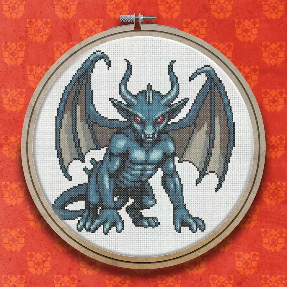 Cross stitch design of a crouching gargoyle with spread bat wings, horns, and a textured silver and grey stone appearance, facing forward.