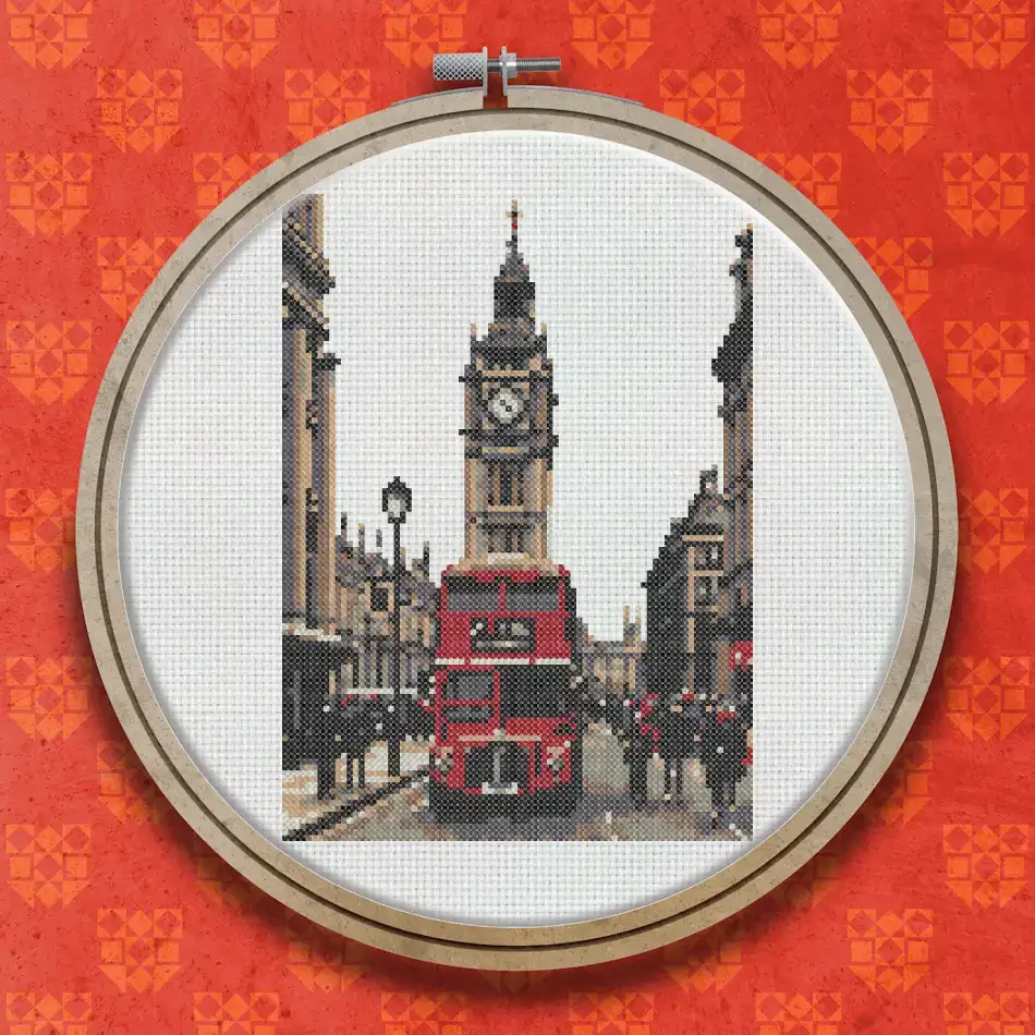 Cross stitch of a London street scene with a red double-decker bus, a tall clock tower, period buildings and pedestrians on the pavement.