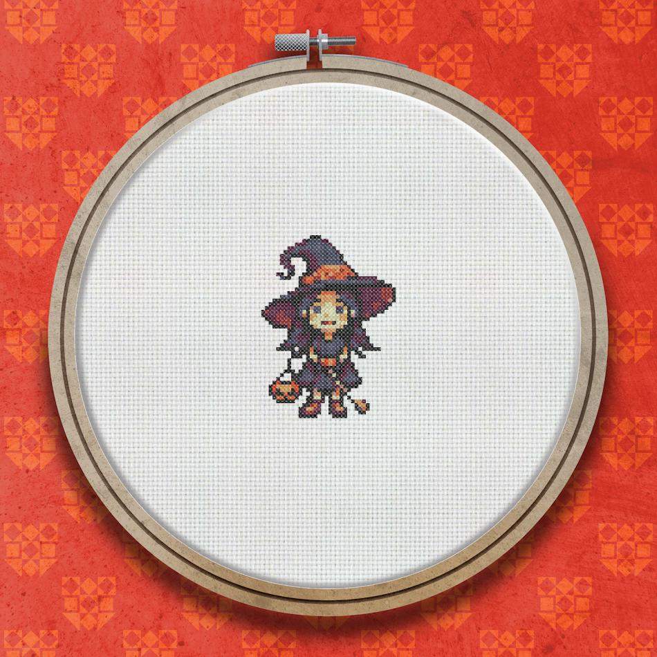 A small cross stitch design of a witch in a black pointed hat and purple dress holding an orange pumpkin, with long dark hair and a friendly expression.