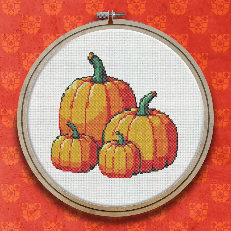 A group of five orange pumpkins of varying sizes arranged together, with green stems, shown in a warm autumnal colour palette.