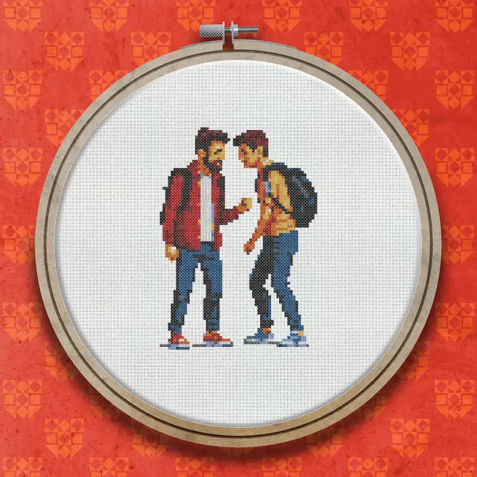 Cross stitch design showing a father and son facing each other in conversation, one in a red jacket and one in a blue hoodie with a backpack.