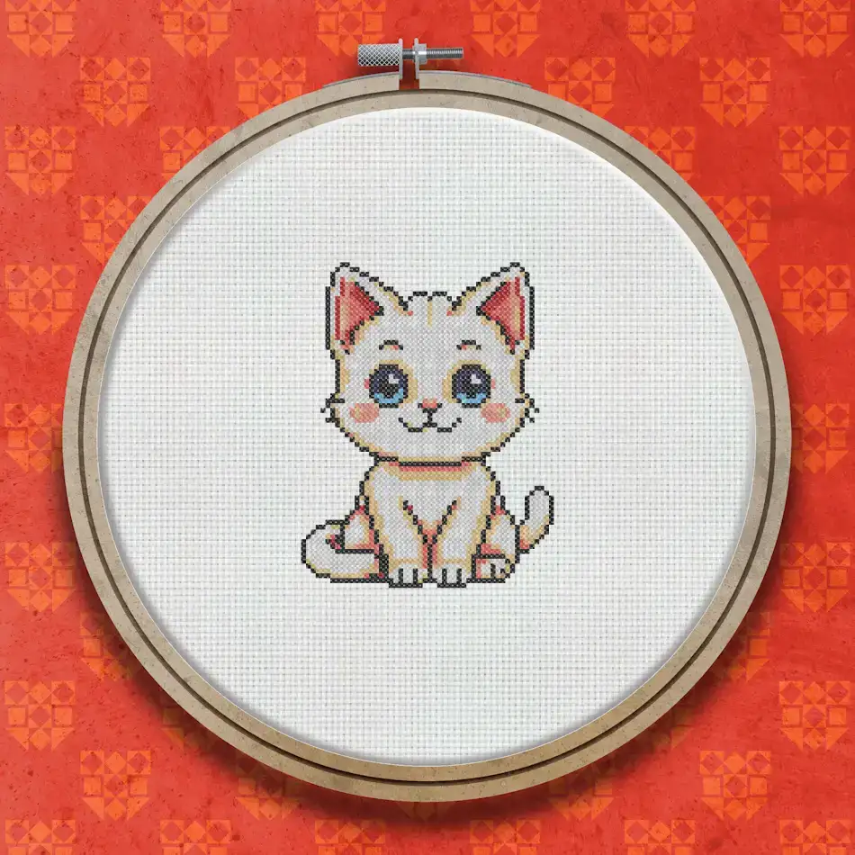 Cross stitch design of a small cream and white kitten sitting upright, with rosy cheeks, blue eyes, and a striped tail, on a white background.
