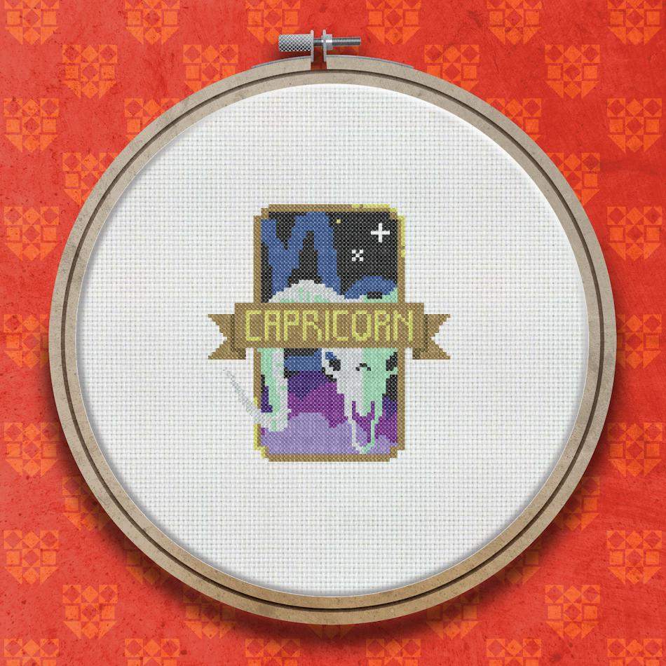 Cross stitch pattern showing the word Capricorn with a goat emblem, purple and teal stars, and a decorative celestial badge design.