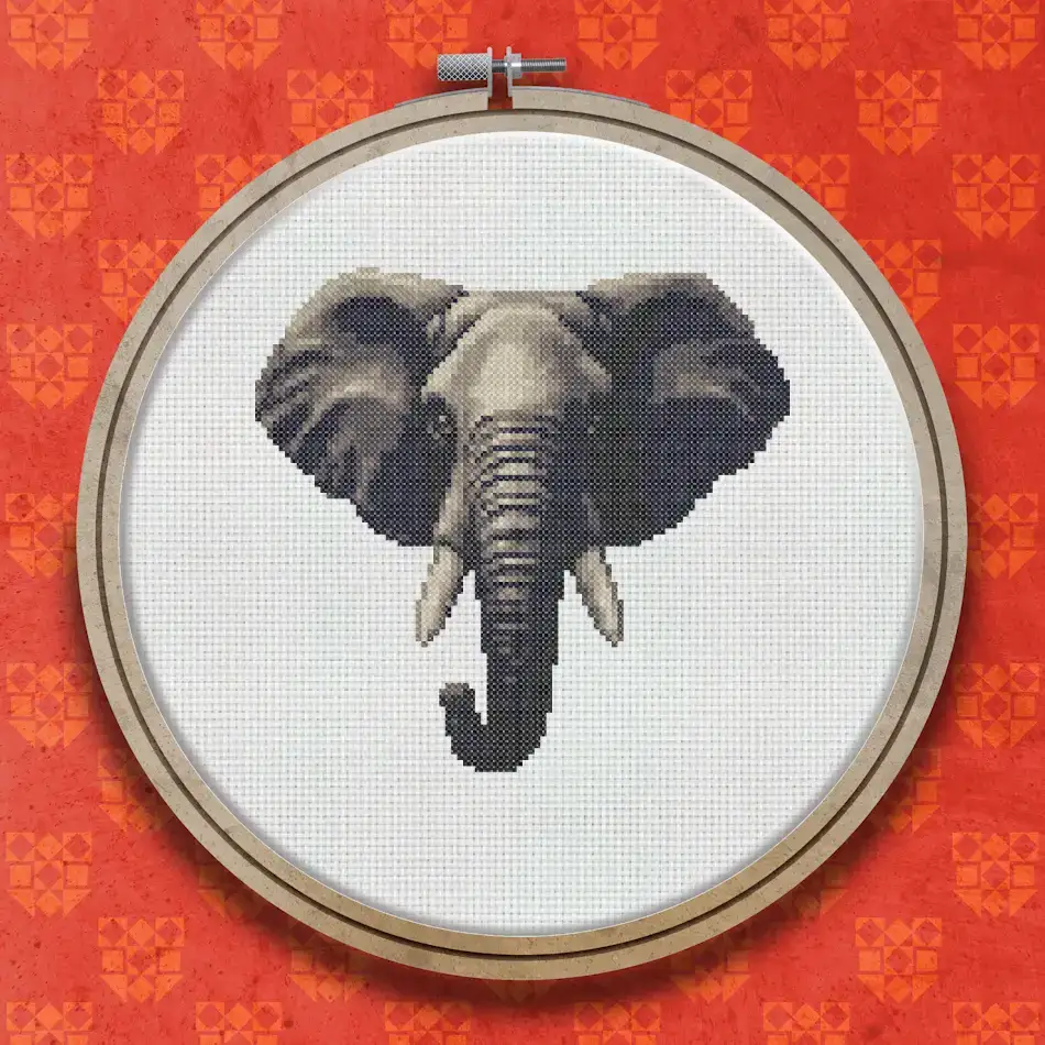 Cross stitch design of an African elephant facing forward, showing detailed grey tones, large tusks, and expressive eyes against a white background.
