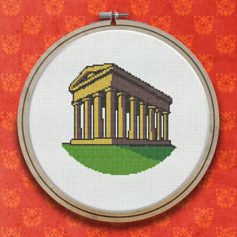 Cross stitch design of a neoclassical colonnaded monument in golden stone on a green hill beneath a pale blue sky.