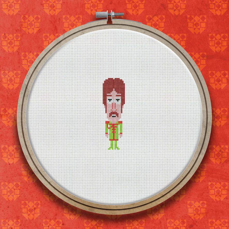 Cross stitch portrait of a man with a brown mop-top hairstyle wearing a colourful striped jacket in red, yellow, and blue tones.