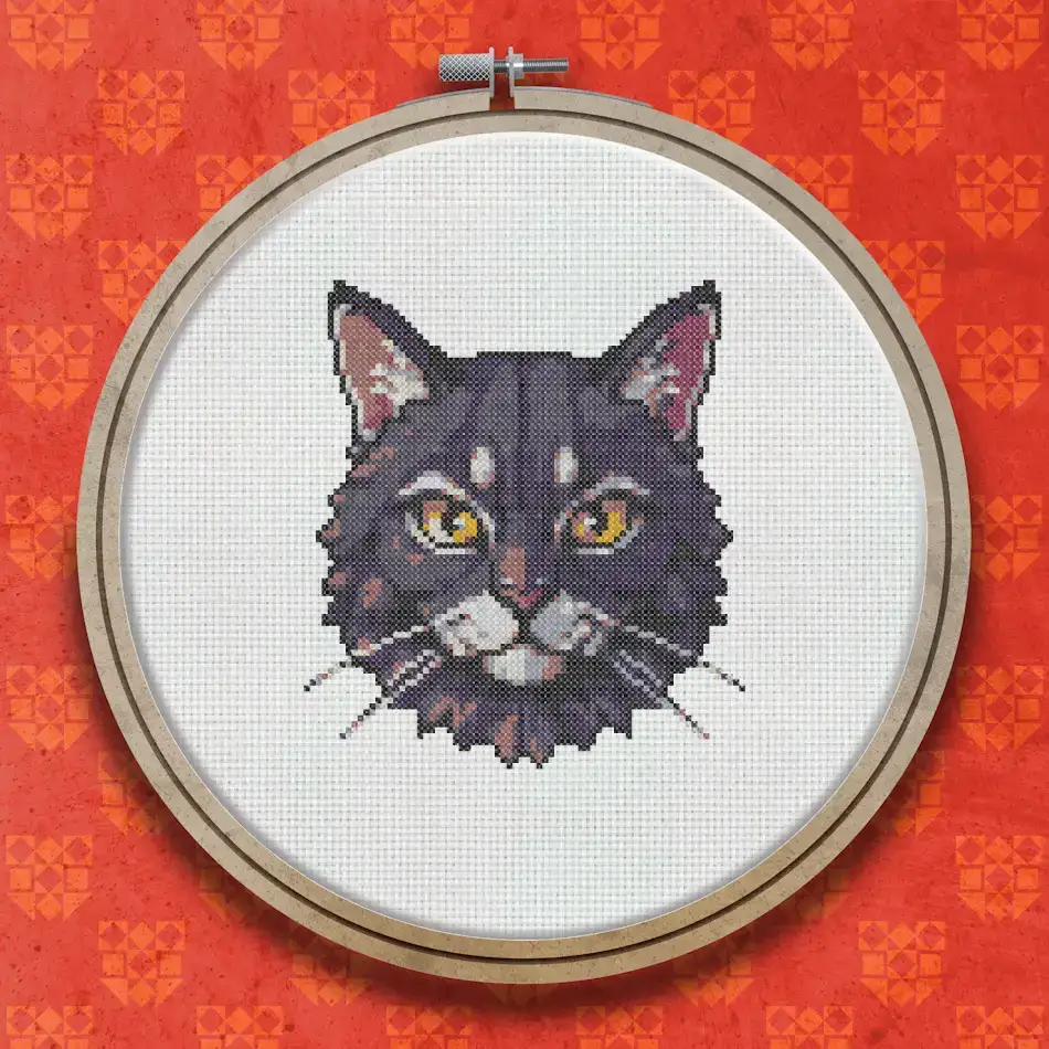 Cross stitch portrait of a dark grey and black cat with bright golden eyes, shown as a close-up face against a light background.