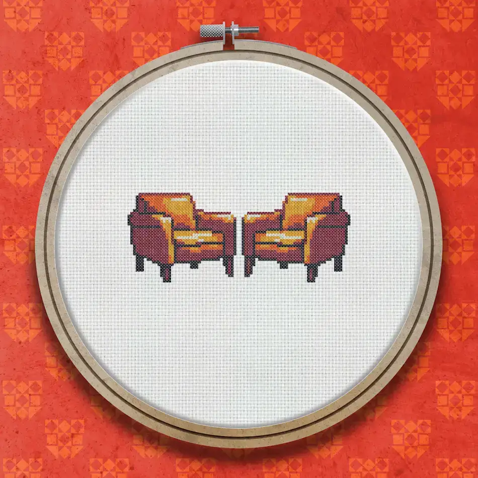 Two orange-brown retro armchairs with dark wooden legs shown side by side in a cross stitch design.