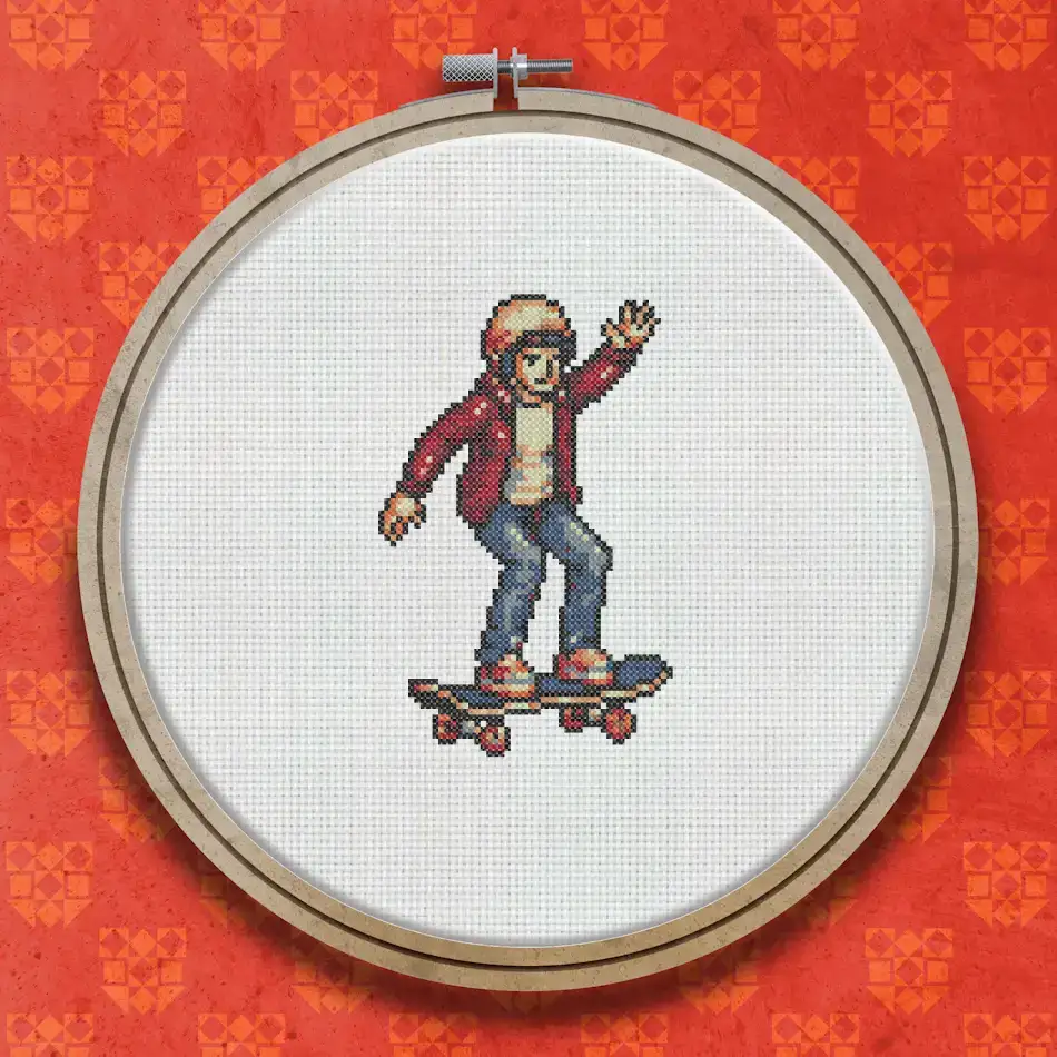 Cross stitch pattern of a skateboarder in a red jacket and helmet riding a skateboard, shown in a lively side pose.