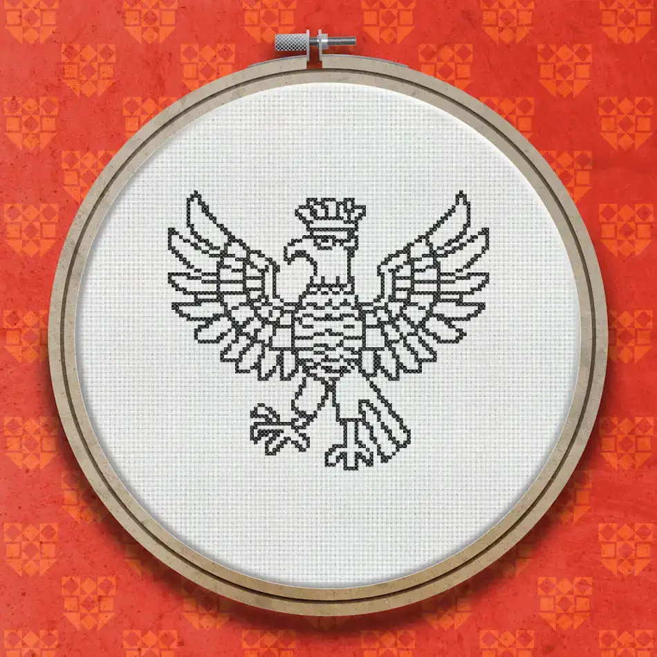 Cross stitch pattern of an eagle with wings spread wide, shown in a bold single-colour woodcut illustration style with detailed feather linework.