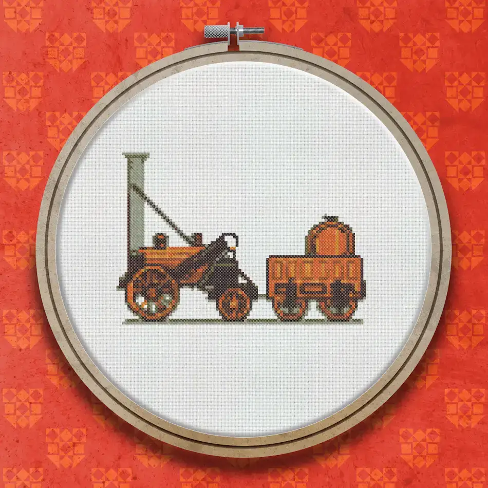 Cross stitch design of a vintage steam locomotive in orange and brown with a cylindrical boiler, tall chimney, large spoked wheels, and an attached tender wagon.