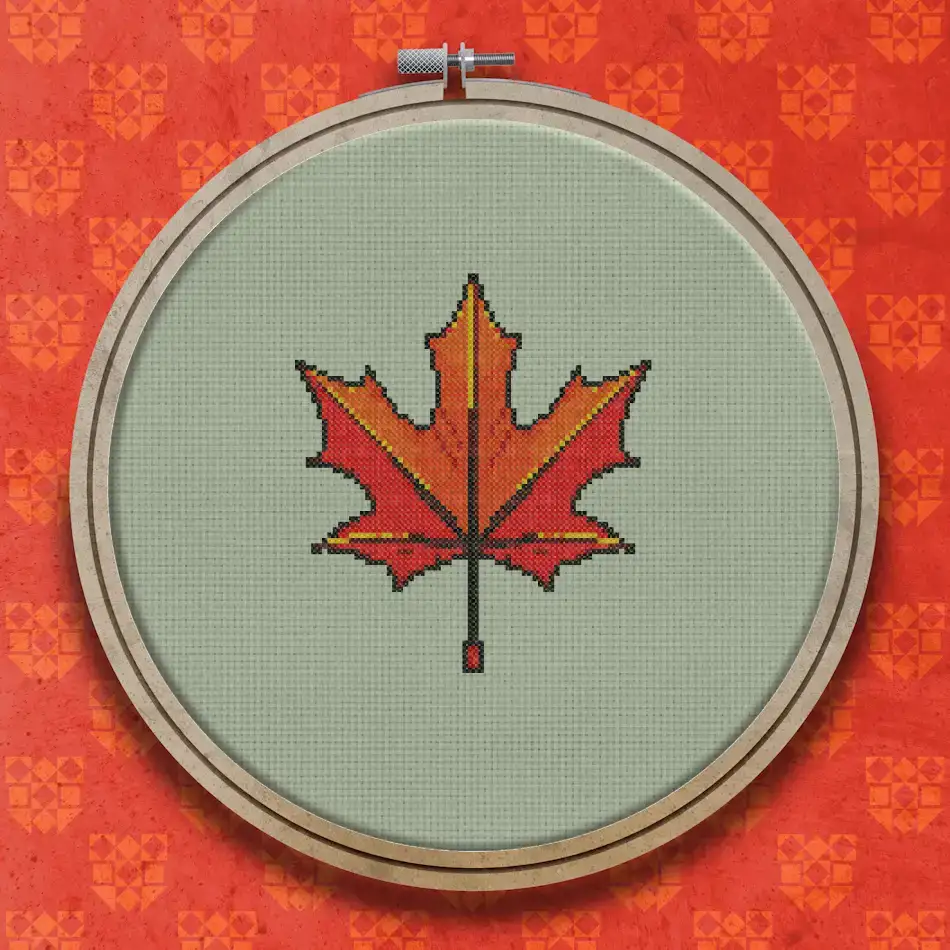 A single maple leaf in shades of red, orange and gold with darker veins and a short brown stem, on a plain white background