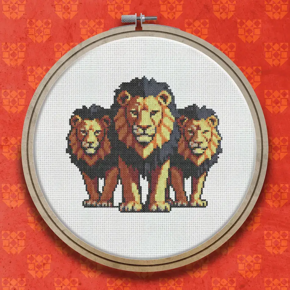 Cross stitch design showing three lions standing together facing forward, with full golden-brown manes and tawny coats against a plain background.
