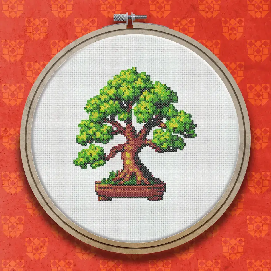 Cross stitch bonsai tree with a dense green leafy canopy, brown trunk and roots, displayed in a rectangular terracotta pot.