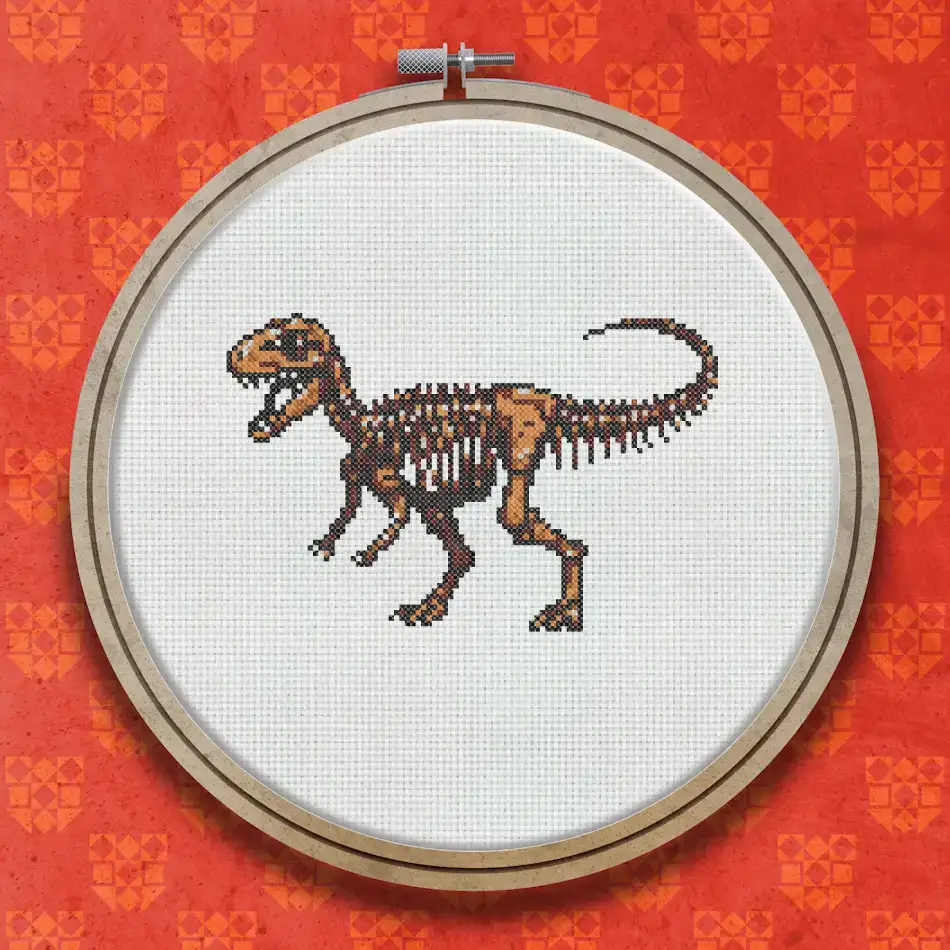 Cross stitch pattern of a dinosaur skeleton in brown and tan tones, shown in side profile with detailed bones, tail, and skull visible.