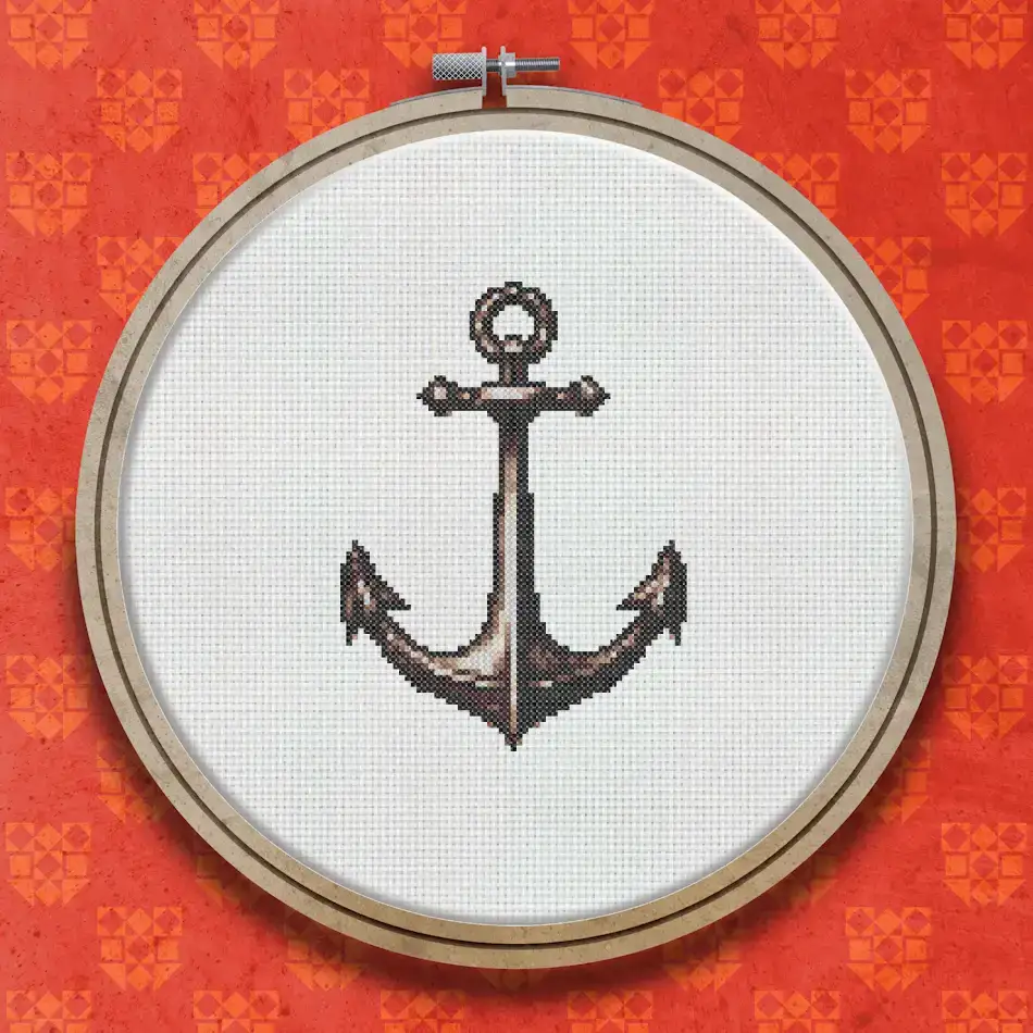 Cross stitch pattern of a traditional anchor in warm brown and rust tones with a rope ring at the top and curved flukes at the base.